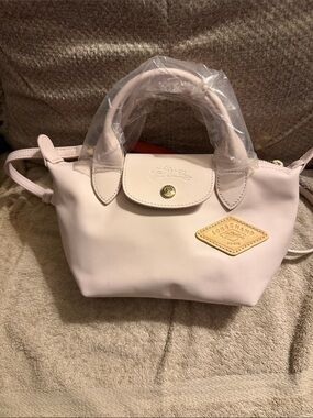 Longchamp Le Pliage extra XS leather satchel in pale pink with gold-tone badge